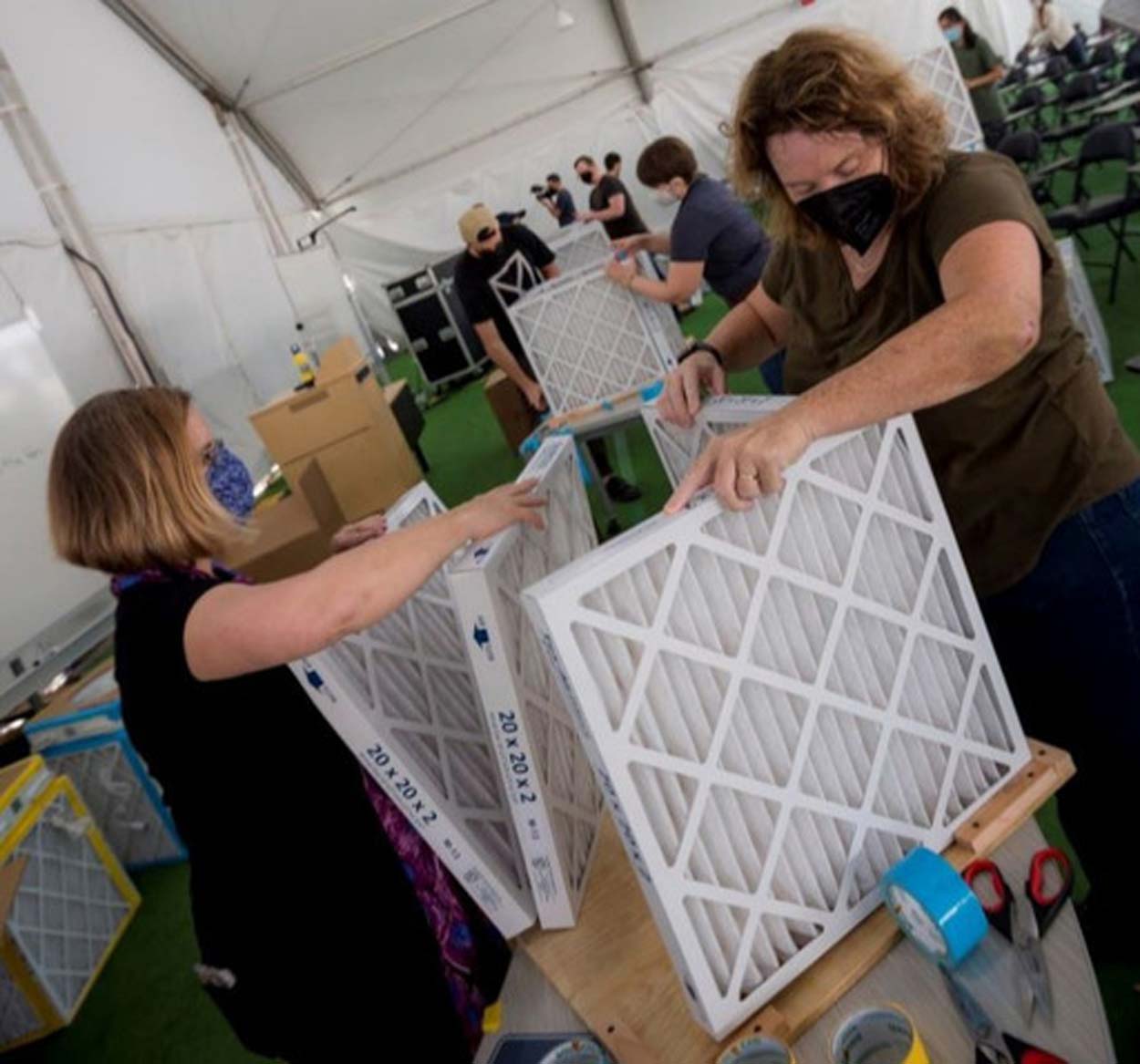 Two women building a filtration box together